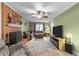 Cozy living room featuring a brick fireplace, plush seating, and ceiling fan at 3608 Meadow Creek Ln, Raleigh, NC 27616