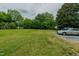 Spacious green backyard with mature trees provides a private and serene setting at 403 Rolling Rd, Haw River, NC 27258