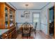 A simple dining area has a round table, an elegant light fixture, and an attractive wood china cabinet at 403 Rolling Rd, Haw River, NC 27258