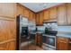 Traditional kitchen features wood cabinets and stainless steel appliances at 403 Rolling Rd, Haw River, NC 27258