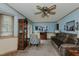 Inviting living room features a ceiling fan, comfortable seating, and ample natural light at 403 Rolling Rd, Haw River, NC 27258