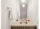 Stylish powder room with stone countertop, brushed nickel fixtures, and neutral paint at 404 S Camellia St, Chapel Hill, NC 27516