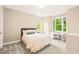 Bright bedroom with large windows, comfortable bed, and desk, offering a peaceful space at 404 S Camellia St, Chapel Hill, NC 27516