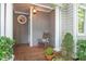 Inviting front porch with brick floor, white columns, and comfortable rocking chair at 404 S Camellia St, Chapel Hill, NC 27516