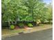 Charming home with mature trees and shrubs, offering curb appeal and shade at 404 S Camellia St, Chapel Hill, NC 27516