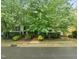 Charming home with mature trees and shrubs, offering curb appeal and shade at 404 S Camellia St, Chapel Hill, NC 27516