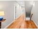 Hallway with hardwood floors leading to stairway and other rooms at 404 S Camellia St, Chapel Hill, NC 27516
