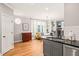 Open concept kitchen with granite countertops and hardwood floors with view to living area at 404 S Camellia St, Chapel Hill, NC 27516