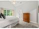 Bedroom featuring a vaulted ceiling, neutral carpet, large window, and dresser at 404 S Camellia St, Chapel Hill, NC 27516