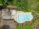 A picturesque aerial view of a community pool and pool house surrounded by mature trees and well-maintained landscaping at 404 S Camellia St, Chapel Hill, NC 27516