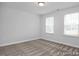 Bedroom featuring neutral carpet and two windows, offering a serene living space at 428 Longleaf Glen Lane, Zebulon, NC 27597