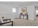 Spacious bonus room with neutral carpet, window, console table, and stylish decor at 428 Longleaf Glen Lane, Zebulon, NC 27597