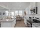 Modern kitchen features a breakfast bar, stainless steel appliances, and sleek cabinetry at 428 Longleaf Glen Lane, Zebulon, NC 27597
