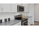 Modern kitchen with stainless steel appliances, sleek countertops, and stylish accents at 428 Longleaf Glen Lane, Zebulon, NC 27597