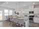 Bright kitchen boasts stainless steel appliances, an island with seating, and a dining area at 428 Longleaf Glen Lane, Zebulon, NC 27597