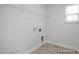 Utility room with space for laundry machines, storage, and natural light at 428 Longleaf Glen Lane, Zebulon, NC 27597