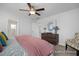 Cozy main bedroom featuring a ceiling fan, dresser with decor, and a patterned chair at 428 Longleaf Glen Lane, Zebulon, NC 27597