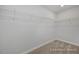 Large walk-in closet with carpet and wire shelving for optimal storage and organization at 428 Longleaf Glen Lane, Zebulon, NC 27597
