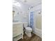 Neat bathroom has vanity with marble top, toilet, and a patterned shower curtain, offering functionality at 4508 Cobble Creek Ln, Raleigh, NC 27616