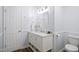 Well-lit bathroom features a white vanity with marble top, a toilet, and a white paneled door at 4508 Cobble Creek Ln, Raleigh, NC 27616