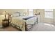 Comfortable bedroom with a decorative bed frame, bedside lamps, and a round mirror above a dresser at 4508 Cobble Creek Ln, Raleigh, NC 27616
