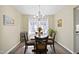 Cozy dining room with a chandelier, dining table, and large window for natural light at 4508 Cobble Creek Ln, Raleigh, NC 27616