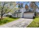 Charming two-story home with a yellow door, blue shutters, and beautiful landscaping at 4508 Cobble Creek Ln, Raleigh, NC 27616