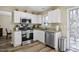 Modern kitchen with stainless steel appliances, granite countertops, and bright white cabinets at 4508 Cobble Creek Ln, Raleigh, NC 27616