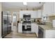 Well-equipped kitchen featuring stainless steel appliances, granite countertops, and ample cabinetry at 4508 Cobble Creek Ln, Raleigh, NC 27616