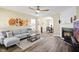 Inviting living room featuring a fireplace, hardwood floors, and an open archway to dining at 4508 Cobble Creek Ln, Raleigh, NC 27616
