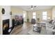 Comfortable living room with a fireplace, hardwood floors, and large windows for natural light at 4508 Cobble Creek Ln, Raleigh, NC 27616