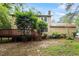 Back of house and deck showcasing fenced-in yard with mature trees at 4812 Kaplan Dr, Raleigh, NC 27606
