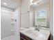Bathroom with a shower, mirror, and window with natural light at 4812 Kaplan Dr, Raleigh, NC 27606
