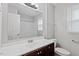 Bathroom featuring dark wood cabinets, a large mirror, and a shower/tub combo at 4812 Kaplan Dr, Raleigh, NC 27606