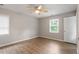 This is a spacious bedroom with wood-look floors, a ceiling fan, and a window at 4812 Kaplan Dr, Raleigh, NC 27606