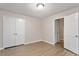 Neutral bedroom featuring wood-look floors and double door closet at 4812 Kaplan Dr, Raleigh, NC 27606