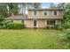 Charming two-story home featuring a well-maintained lawn and traditional architectural details at 4812 Kaplan Dr, Raleigh, NC 27606