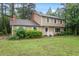 Traditional home exterior showcasing a symmetrical design, manicured lawn, and mature landscaping at 4812 Kaplan Dr, Raleigh, NC 27606