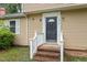 Inviting entrance showcasing the front door with white trim and brick steps at 4812 Kaplan Dr, Raleigh, NC 27606