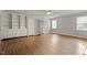 Spacious living room with built-in shelves and cabinets, hardwood floors, and natural lighting at 4812 Kaplan Dr, Raleigh, NC 27606