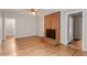 Bright living room featuring a brick fireplace, ceiling fan, and wood-look flooring throughout at 4812 Kaplan Dr, Raleigh, NC 27606