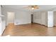 Open-concept living room with hardwood floors, ceiling fan, and adjacent doorways at 4812 Kaplan Dr, Raleigh, NC 27606
