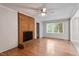 Bright living room featuring a brick fireplace, ceiling fan, and wood-look flooring throughout at 4812 Kaplan Dr, Raleigh, NC 27606