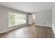 Inviting living room with luxury vinyl floors, a large window, and neutral color scheme at 4812 Kaplan Dr, Raleigh, NC 27606