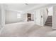 Spacious basement features a brick fireplace, neutral carpet, and access to the upper floors at 5001 Simpson Dr, Sanford, NC 27330