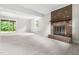 Finished basement features neutral carpet, a brick fireplace, and a sliding glass door at 5001 Simpson Dr, Sanford, NC 27330