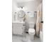 Bathroom with white marble flooring, sink vanity with black hardware, and colorful shower curtain at 5001 Simpson Dr, Sanford, NC 27330