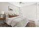 Bright bedroom with a white bed, neutral walls, a ceiling fan, comfortable bed, decorative pillows, and natural light at 5001 Simpson Dr, Sanford, NC 27330