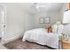 Comfortable bedroom featuring a white bed, ceiling fan, neutral walls, decorative pillows, and natural light at 5001 Simpson Dr, Sanford, NC 27330