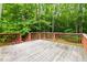 Wooden deck overlooking a private, wooded backyard—a perfect outdoor relaxation spot at 5001 Simpson Dr, Sanford, NC 27330